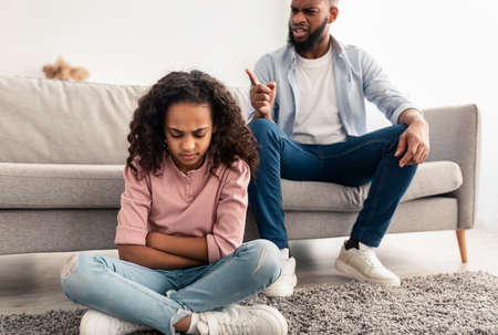 Family Conflict. Angry black father scolding sad daughterの写真素材