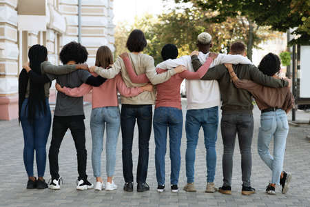 Back view of people hugging while standing on the streetの写真素材