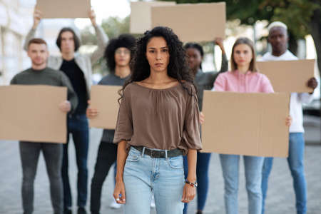 Active woman leading a group of demonstrators on the streetの写真素材