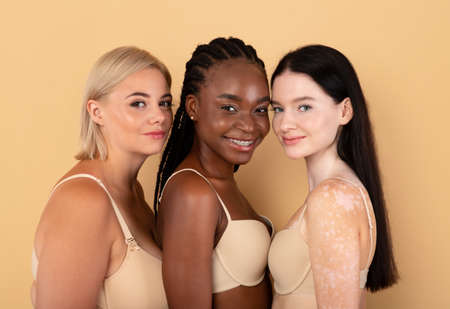 Different Beauty. Three Body Positive Females In Underwear Posing Over Beige Backgroundの写真素材