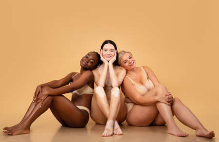 Group of multiethnic women with different body and skin types posing togetherの写真素材
