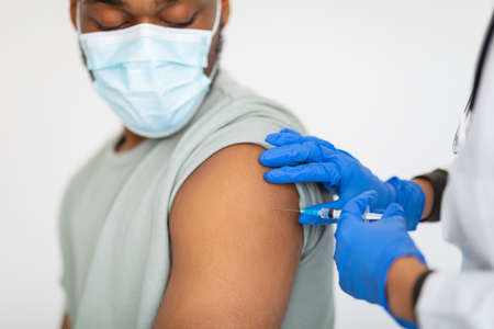 Black Guy In Mask Getting Vaccinated Against, White Background