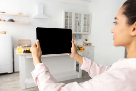 Woman using digital tablet with blank empty screen, mockupの写真素材
