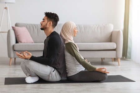 Yoga for Pregnancy and Childbirth. Expecting islamic spouses meditating together at homeの写真素材