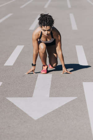 Training sportswoman outdoor at stadium, workout alone during   quarantine