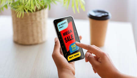 Black woman showing smartphone with shopping application screen