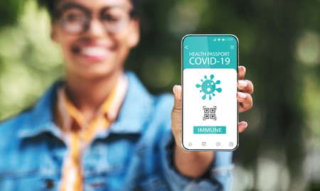 Black lady showing smartphone with Immune digital passport for covid