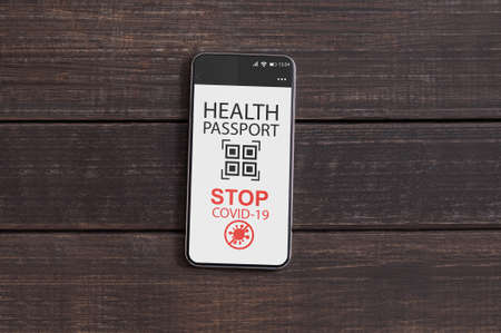 Smartphone with digital immune passport for covid on screenの写真素材