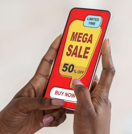Black lady using shopping application on smartphone, closeup