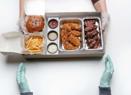 Fried unhealthy appetizing food and fast contactless home delivery