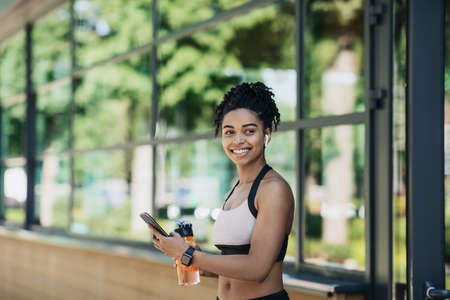 Beautiful muscular trainer, fitness blogger and workout outdoorの写真素材