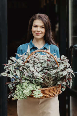 Delivery online order, work of gardener, seller, florist and owner of studio outdoorの写真素材