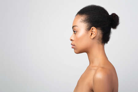 Side-View Portrait Of African Woman Looking At Copyspace, Gray Backgroundの写真素材