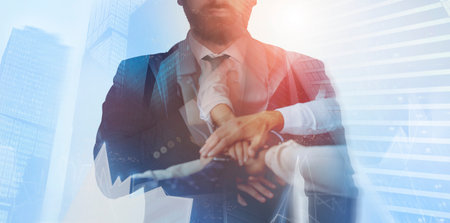 Cropped of transparent businessman in suit over skyscrapersの写真素材