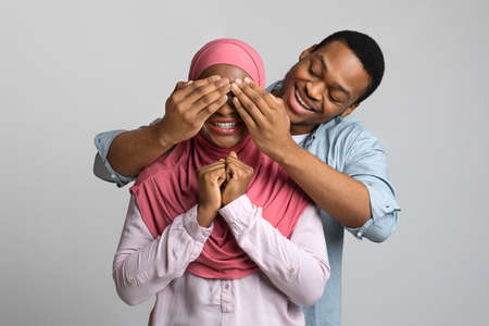 Loving black guy covering his emotional girlfriend eyes
