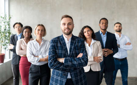 Businessman Standing In Front Of His Business Team In Officeの写真素材
