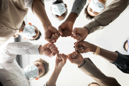 Portrait of diverse business people giving fist bump in cirleの写真素材