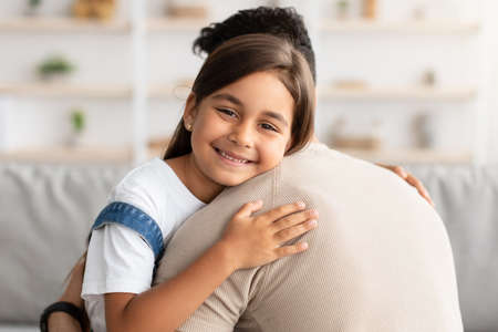 Portrait of father and daughter hugging at homeの写真素材