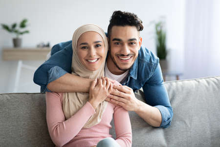 Portrait of loving muslim couple embracing at homeの写真素材