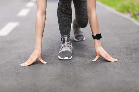 Ready, Steady, Go. Female Runner Standing In Starting Position On Path Outdoorsの写真素材