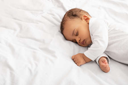 Little Baby Boy Sleeping Peacefully Lying In Bed Indoors