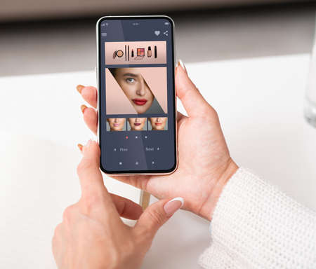 Augmented Reality Beauty App. Woman Trying Different Lipstick Color Onlineの写真素材