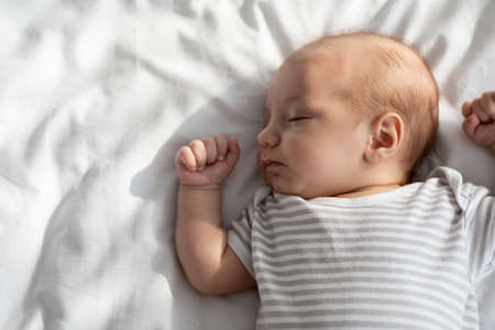 Daysleep. Closeup Portrait Of Adorable Little Baby Sleeping In Bedの写真素材