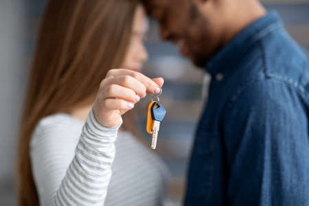 New Home Concept. Closeup Shot Of Young Interracial Couple Holding Keysの写真素材