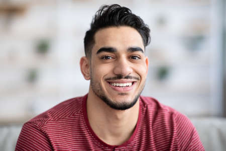 Closeup portrait of cheerful handsome arab guy