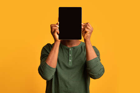 Funny African American Man Covering Face With Digital Tablet With Black Screen