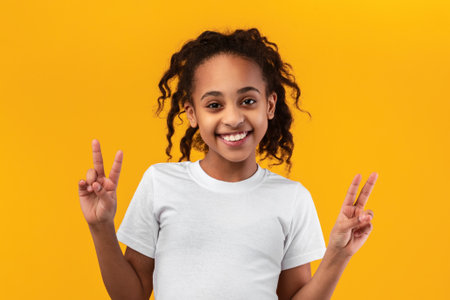 Portrait of smiling black teen girl showing peace sign
