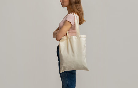 Side View Shot Of Young Woman Carrying Blank Eco Tote Canvas Bag