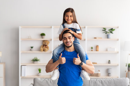 Cheerful Man Riding Excited Daughter On His Shouldersの写真素材