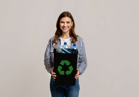 Beautiful Young Lady Carrying Container With Empty Plastic Bottles Ready For Recycling