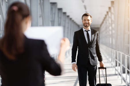 Female representative meeting business partner in airport