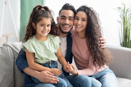 Portrait Of Happy Young Middle Eastern Family Of Three With Little Daughterの写真素材