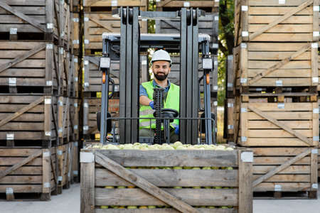 Truck is loaded with containers full of apples, ready to be sent to marketの写真素材