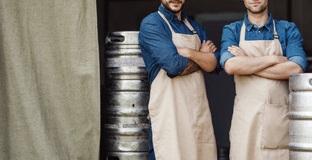 Brewers at work, attractive confident men at plant. Small business, brewery and startupの写真素材