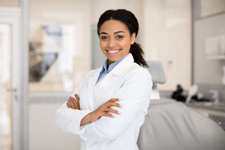Portrait Of Beautiful Professional Black Female Stomatologist Posing In Clinic Interiorの写真素材