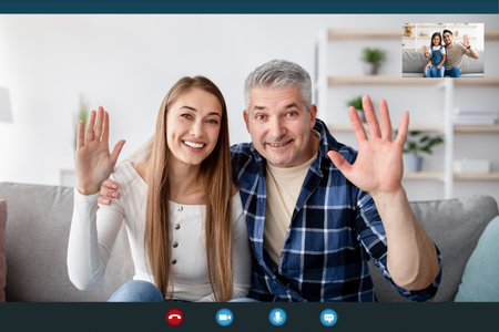 Cheerful mature couple having video chat with their son and granddaughter, waving at webcam, view of screenの素材 [FY310174600973]