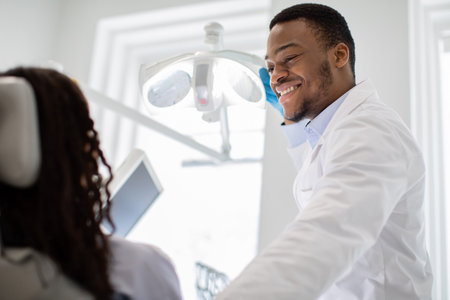 Stomatological Treatment. Black Dentist Doctor Making Check Up To Female Patientの写真素材