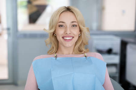 Blonde young woman patient smiling in dentistryの写真素材