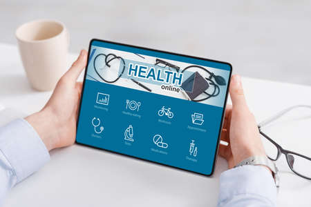 Unrecognizable businessman checking health app while working in office