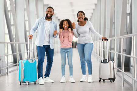 Happy black family traveling with kid, screaming yes
