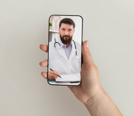 Woman patient choosing doctor on clinic website, using smartphoneの写真素材