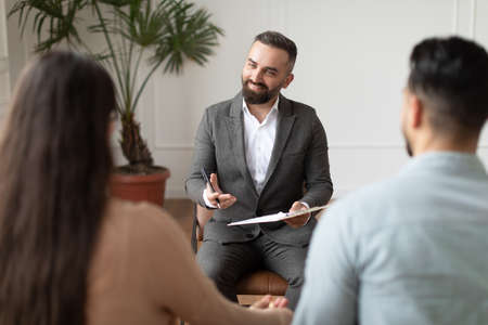 Couple talking at therapy session with male therapist