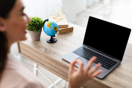 Businesswoman Talking To Laptop Blank Screen Video Calling In Officeの写真素材