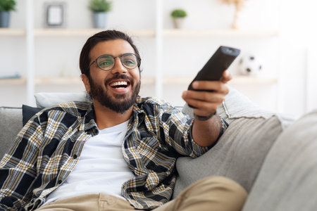 Relaxed arab guy wathcing movie on TV