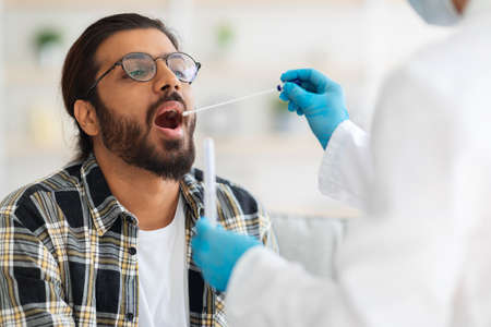 Indian guy getting coronavirus swab test at home