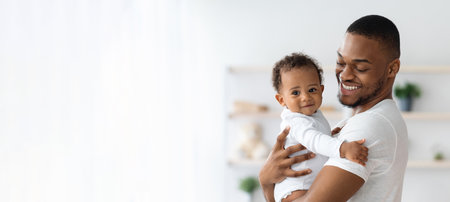 Child Care. Portrait Of Smiling Black Father Holding Newborn Baby In Armsの写真素材